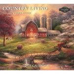 Gracing the cover of the 2025 Calendar Country Living by MyHomeDecor.ca is a picturesque painting by Chuck Pinson. The artwork, titled "Country Living," vividly depicts a serene farm scene featuring a red barn, silo, autumn foliage, a bridge, and animals grazing peacefully. The Pine Ridge Art logo stands out prominently.