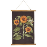 A decorative wall hanging features an illustration of three blooming sunflowers and one budding sunflower, all with yellow-orange petals and green leaves, set against a dark background. This beautiful Sunflower Rolled Canvas Wall Decor - 3 Sunflowers by MyHomeDecor.ca is framed by wooden rods at the top and bottom with a string for hanging.