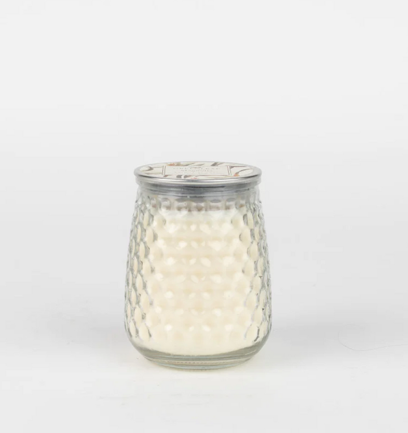 A Large Signature Candle - Magnolia in a glass jar filled with white wax, emanating a Magnolia fragrance. The textured hobnail jar features a dimpled surface and a partially visible metal lid, all set against a plain white background. The candle is by MyHomeDecor.ca.