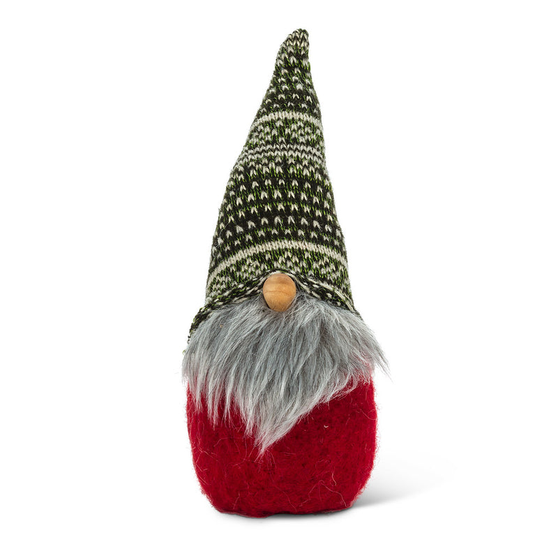 A Medium Gnome - Green and Red from MyHomeDecor.ca, wearing a tall knitted hat and featuring a long gray beard. The medium-sized gnome's body is covered in red fuzzy material, with its nose peeking out from beneath its hat. This charming decorative accessory stands upright against a plain white background.