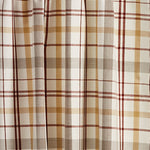 A close-up of the Tiers Pair - Kingswood from MyHomeDecor.ca with horizontal and vertical lines in shades of brown, yellow, red, and beige, forming a traditional plaid design. The fabric appears to be draped or part of a window treatment, adding a charming country look.