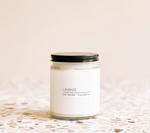 A glass jar with a black lid containing a white candle labeled "Large Soy Candle - Lavender by MyHomeDecor.ca" sits elegantly on a terrazzo surface with a light beige background. Infused with lavender essential oils, this minimalist indoor & outdoor candle is perfect for any space.